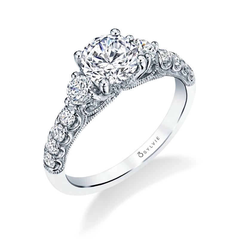 14K WHITE GOLD THREE STONE SEMI MOUNTING WITH .62CTTW ROUND SI1 CLARITY & GH COLOR DIAMONDS SET ON THE SIDES, HALF WAY DOWN THE SHANK AND UNDER THE HEAD BEADED SCROLL WORK ON THE SIDES (1CT ROUND HEAD)